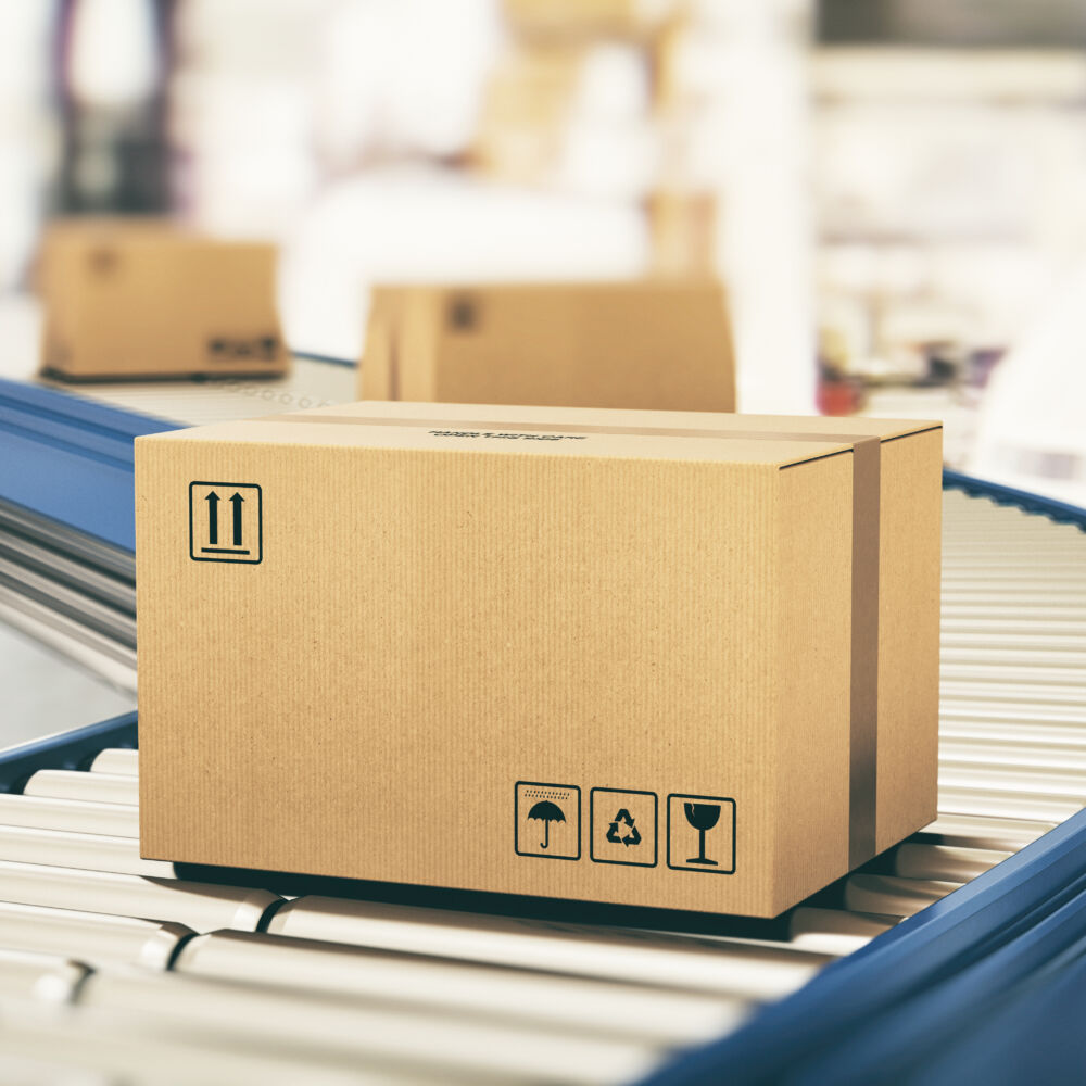 Cardboard boxes on conveyor rollers ready to be shipped by courier for distribution