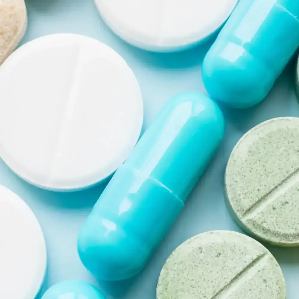 colorful-pills-and-capsules-on-light-blue-backgrou-2026-03-24-08-01-43-utc